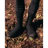 Full view of Spatzwear TUFR2 overshoes worn off-road, on muddy ground with fallen leaves.