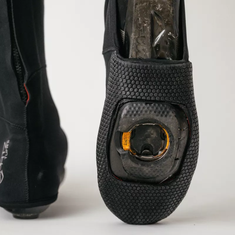 Underside view of Spatzwear TUFR2 overshoes, vulcanised sole with cleat opening.
