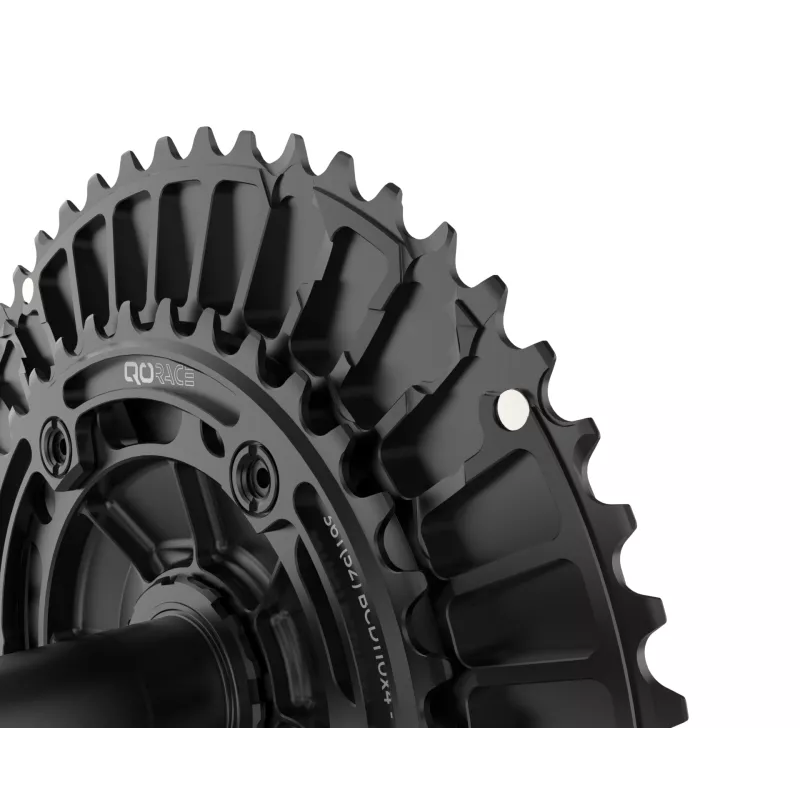 Close-up of QO RACE CNC-machined chainrings, 110x4 BCD, matte black finish with aerodynamic profile.
