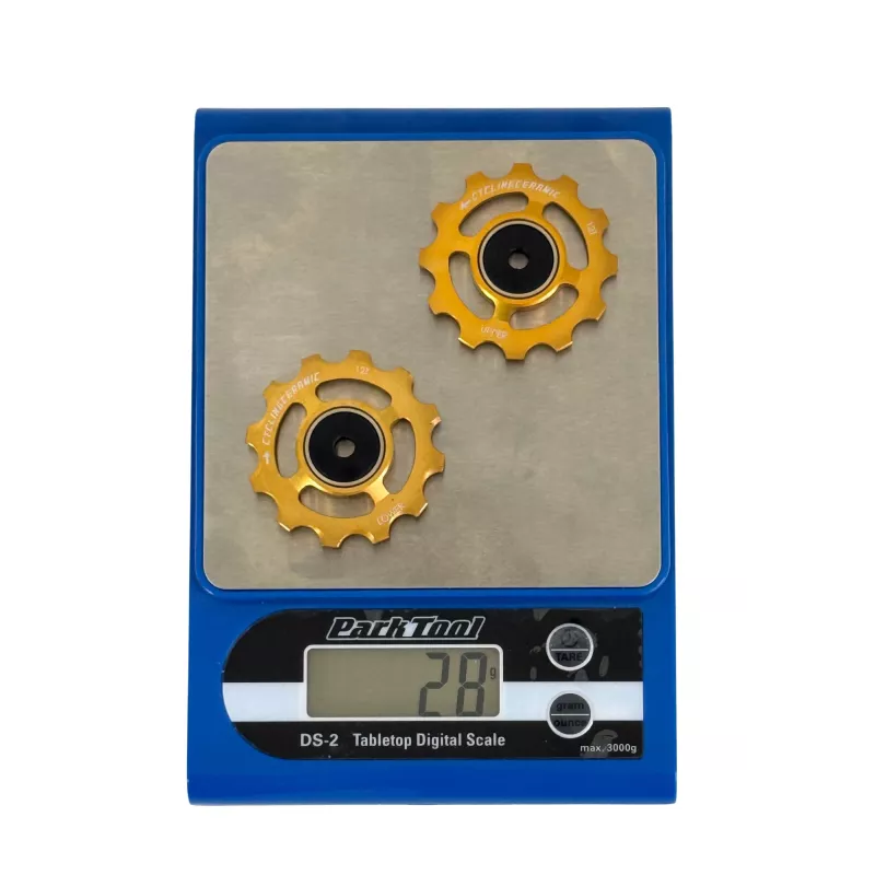 Gold pulley wheels CyclingCeramic on Park Tool balance at just 28g