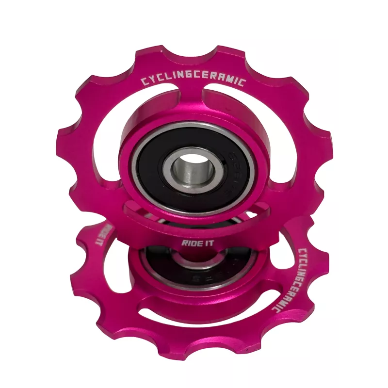 Close-up of limited edition pink CyclingCeramic derailleur pulleys, 11-tooth ceramic pulley wheels for Shimano 11-12s