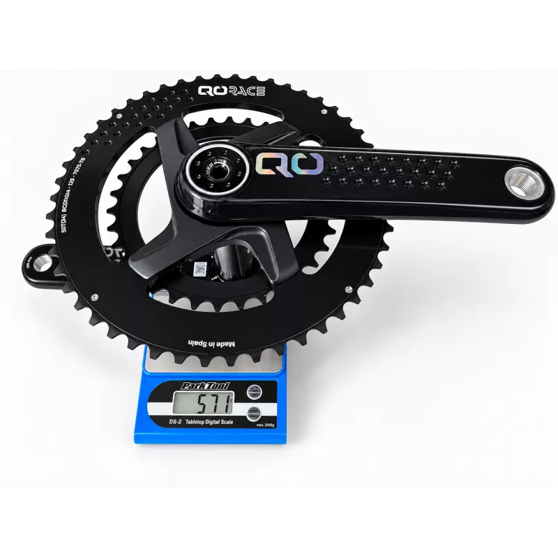 QO Race 50/34T road crankset weighing 571 g on Park Tool scale